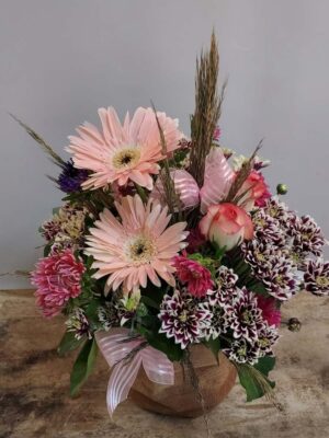 Composition with fresh flowers in burlap pot