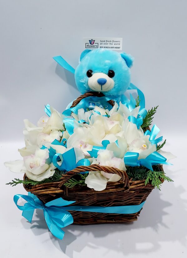 Wonderful composition ΄΄the arrival of a lifetime” for the birth of a boy, in a basket with orchids and a teddy bear!
