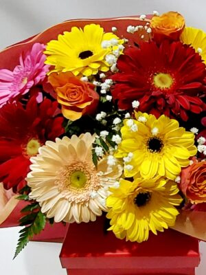 Cheerful colorful bouquet with lovely gerberas and beautiful roses in shades of yellow