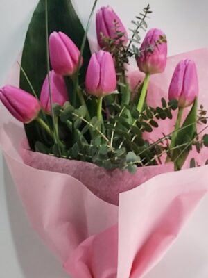 Romantic bouquet with 7 beautiful pink tulips and separate foliage