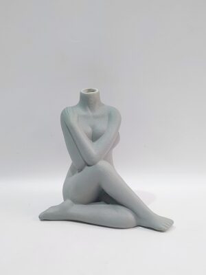 Female body sitting in gray shade. Dimensions 19×12