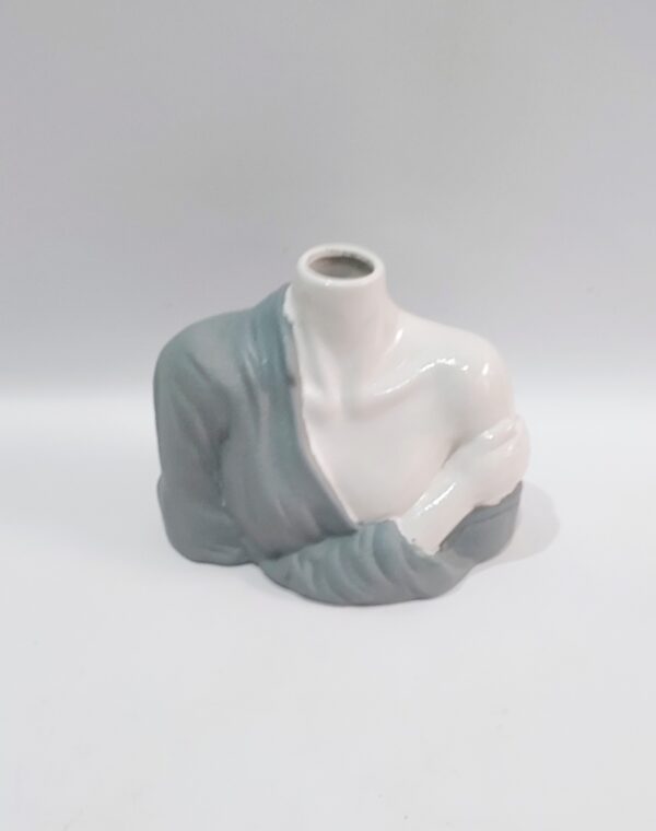 Female headless body dressed in a porcelain tunic. Dimensions 13 height x 19 width